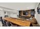 Finished basement featuring a long wooden table, comfortable seating, and a rustic entertainment center at 7319 Farlin Dr, Whitestown, IN 46075