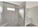 Bright bathroom featuring a tiled shower with glass door and single sink vanity at 7319 Farlin Dr, Whitestown, IN 46075
