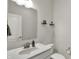 A clean half bath featuring modern fixtures, a sleek mirror, and floating decorative shelves at 7319 Farlin Dr, Whitestown, IN 46075