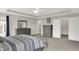 Spacious main bedroom showcases soft carpet, tray ceiling, and neutral walls at 7319 Farlin Dr, Whitestown, IN 46075