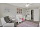 Cozy Bedroom featuring gray chair, crib, patterned rug, closet and cute decor at 7319 Farlin Dr, Whitestown, IN 46075