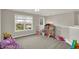 Bright bonus room features a large window and playful dollhouse decor at 7319 Farlin Dr, Whitestown, IN 46075