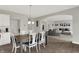Dining room with wood floors, large table, and open view into the living room at 7319 Farlin Dr, Whitestown, IN 46075