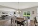 Open concept dining area with hardwood floors, a large table, and a view of the living room at 7319 Farlin Dr, Whitestown, IN 46075