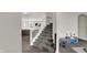 Welcoming entryway featuring a staircase, wood floors, and a glimpse of the living area at 7319 Farlin Dr, Whitestown, IN 46075