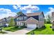 Beautiful two-story home with brick and siding, a well-manicured lawn, and an attached two-car garage at 7319 Farlin Dr, Whitestown, IN 46075