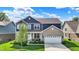 Charming two-story home featuring a brick facade, well-manicured lawn, and attached two-car garage at 7319 Farlin Dr, Whitestown, IN 46075