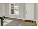 Bright foyer with a large window, a white front door, and neutral decor at 7319 Farlin Dr, Whitestown, IN 46075