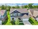 Aerial view of the two-story home displaying brick and siding, a two-car garage, and landscaping at 7319 Farlin Dr, Whitestown, IN 46075