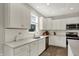 Bright kitchen featuring white cabinets, stainless steel appliances, granite countertops and a large single basin sink at 7319 Farlin Dr, Whitestown, IN 46075