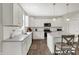 Stylish kitchen with white cabinets, gray countertops, and an island with seating at 7319 Farlin Dr, Whitestown, IN 46075