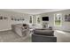 An open-concept living room boasting a large sectional, soft carpet, and multiple windows at 7319 Farlin Dr, Whitestown, IN 46075