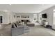 An expansive living room featuring a comfortable sectional sofa, neutral tones, and a TV at 7319 Farlin Dr, Whitestown, IN 46075