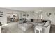 Open-concept living room boasting plush gray furniture, carpet floors, and multiple entries at 7319 Farlin Dr, Whitestown, IN 46075
