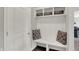 Mudroom features a built in bench with storage cubbies and hooks, perfect for organizing coats and shoes at 7319 Farlin Dr, Whitestown, IN 46075