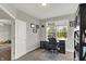 Well-lit home office featuring neutral walls, a large window, and a work desk with black furnishings at 7319 Farlin Dr, Whitestown, IN 46075