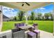 Outdoor patio with patio furniture and a picturesque view of the well-maintained backyard and greenery at 7319 Farlin Dr, Whitestown, IN 46075