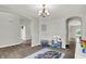 Bright playroom area with hardwood floors, a toy kitchen set, and gray carpet at 7319 Farlin Dr, Whitestown, IN 46075