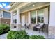 Inviting front porch featuring stylish chairs, ample seating space, and attractive landscaping at 7319 Farlin Dr, Whitestown, IN 46075