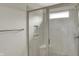 Modern glass enclosed shower with built-in shelving for storage of shower products at 7319 Farlin Dr, Whitestown, IN 46075