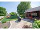 Expansive backyard featuring a patio, grilling area, lush lawn, and a charming screened-in porch at 7450 Cotherstone Ct, Indianapolis, IN 46256