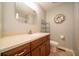 Bathroom with wood cabinet vanity with a sink, mirror, toilet and a shower at 7450 Cotherstone Ct, Indianapolis, IN 46256