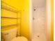 Bright yellow bathroom featuring a stand up shower with white tile surround at 7450 Cotherstone Ct, Indianapolis, IN 46256