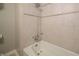 Bathroom detail showcasing a tub with chrome shower fixtures and tile surround at 7450 Cotherstone Ct, Indianapolis, IN 46256