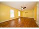 Large bedroom with wood laminate flooring, ceiling fan, and ample natural light at 7450 Cotherstone Ct, Indianapolis, IN 46256