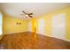 Spacious, light-filled bedroom featuring a ceiling fan and wood-look flooring at 7450 Cotherstone Ct, Indianapolis, IN 46256