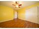 Bedroom with closet space, hardwood floors, white trim, ceiling fan and a window at 7450 Cotherstone Ct, Indianapolis, IN 46256