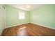 Bedroom with hardwood floors, white trim, ceiling fan and a window with natural light at 7450 Cotherstone Ct, Indianapolis, IN 46256