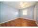 Cozy bedroom with hardwood floors, ceiling fan and a window that provides natural light at 7450 Cotherstone Ct, Indianapolis, IN 46256