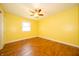 Bedroom with hardwood floors, white trim, ceiling fan and a window with natural light at 7450 Cotherstone Ct, Indianapolis, IN 46256