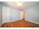 Comfortable bedroom featuring hardwood floors, ceiling fan and two doors at 7450 Cotherstone Ct, Indianapolis, IN 46256