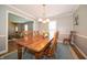 Inviting dining room featuring a wood table, classic chandelier, and neutral paint at 7450 Cotherstone Ct, Indianapolis, IN 46256