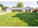 Charming one-story home featuring a well-manicured lawn and brick accents at 7450 Cotherstone Ct, Indianapolis, IN 46256