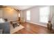 Cozy living room with natural light, hardwood floors, and vaulted ceilings at 7450 Cotherstone Ct, Indianapolis, IN 46256