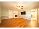Inviting living room featuring hardwood floors, fireplace, and an installed television at 7450 Cotherstone Ct, Indianapolis, IN 46256