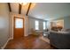 Bright living room with hardwood floors, beamed ceilings, and neutral paint at 7450 Cotherstone Ct, Indianapolis, IN 46256
