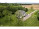 A high aerial view of a beautiful home surrounded by trees, showing the driveway and landscaped grounds at 8555 S County Road 375 E, Mooresville, IN 46158