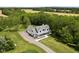 Stunning aerial view of a two-story home surrounded by lush greenery and a long driveway leading to the house at 8555 S County Road 375 E, Mooresville, IN 46158