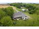 Attractive aerial view showcasing the home with a large backyard, patio and play set at 8555 S County Road 375 E, Mooresville, IN 46158