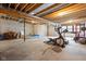Unfinished basement with exposed ceiling, concrete floor, and potential for customization, fitness equipment included at 8555 S County Road 375 E, Mooresville, IN 46158