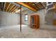 Unfinished basement featuring exposed ceiling, concrete floor, and a sauna room ready for custom designs at 8555 S County Road 375 E, Mooresville, IN 46158