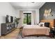 Bright bedroom with access to outdoor patio, stylish furniture, and hardwood flooring at 8555 S County Road 375 E, Mooresville, IN 46158