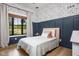 Charming bedroom with floral wallpaper, board and batten accent wall, and a cozy bed next to a window at 8555 S County Road 375 E, Mooresville, IN 46158