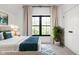 Bright bedroom featuring a large window, blue accents, neutral walls and decor, and a cozy, modern aesthetic at 8555 S County Road 375 E, Mooresville, IN 46158