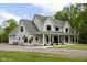Beautiful two-story home featuring a spacious covered front porch, an attached garage, and an American flag at 8555 S County Road 375 E, Mooresville, IN 46158