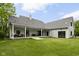 Back exterior view of house with long covered porch, garage, and yard at 8555 S County Road 375 E, Mooresville, IN 46158